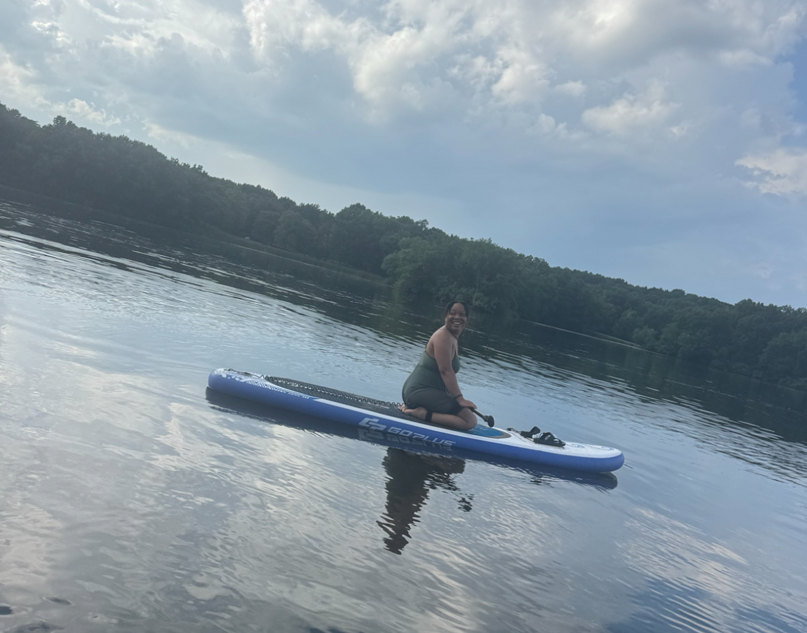 Ashleigh paddleboarding on calm water